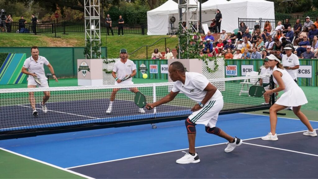 Diverse group playing pickleball on outdoor court